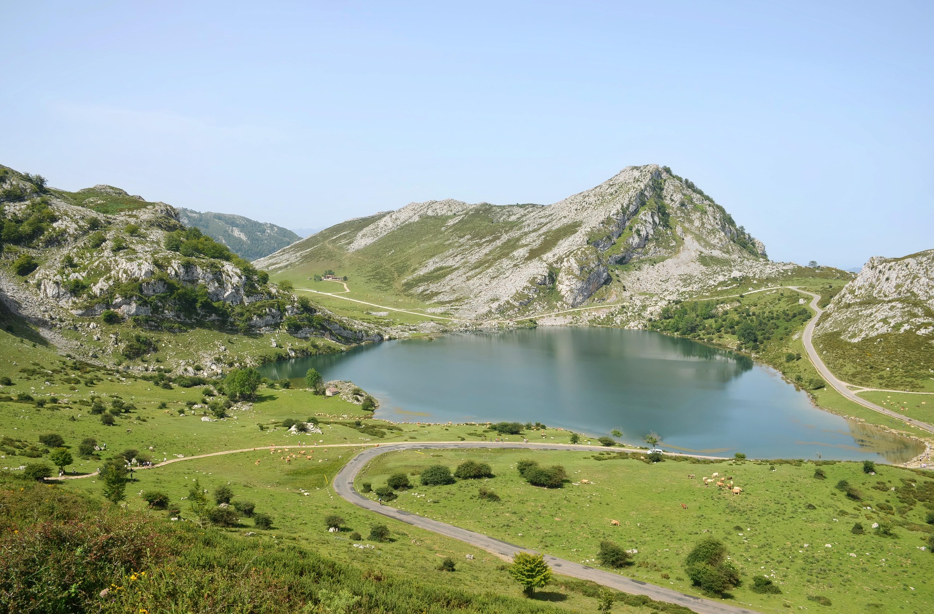 A couple standing before a grand, traditional stone gate in a travel destination.